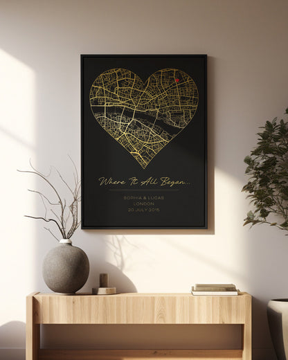 A black and gold map print in a heart shape marking a special location, titled &quot;Where It All Began.&quot;