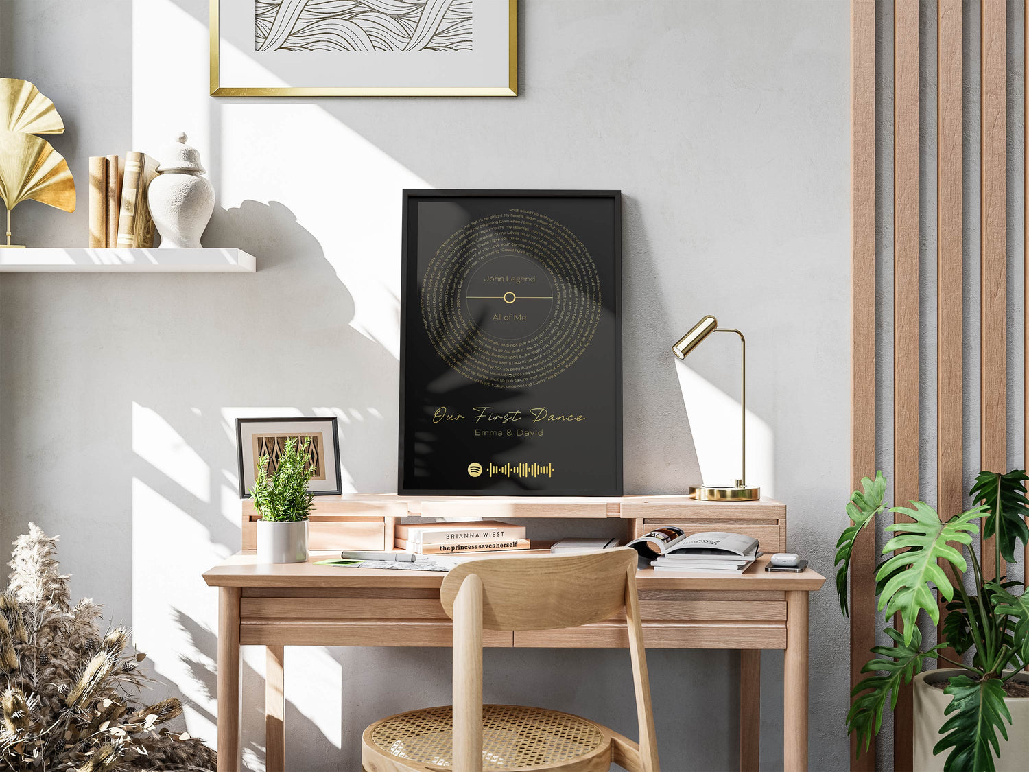  Modern workspace with a framed black print featuring golden soundwaves, titled "Our First Dance".