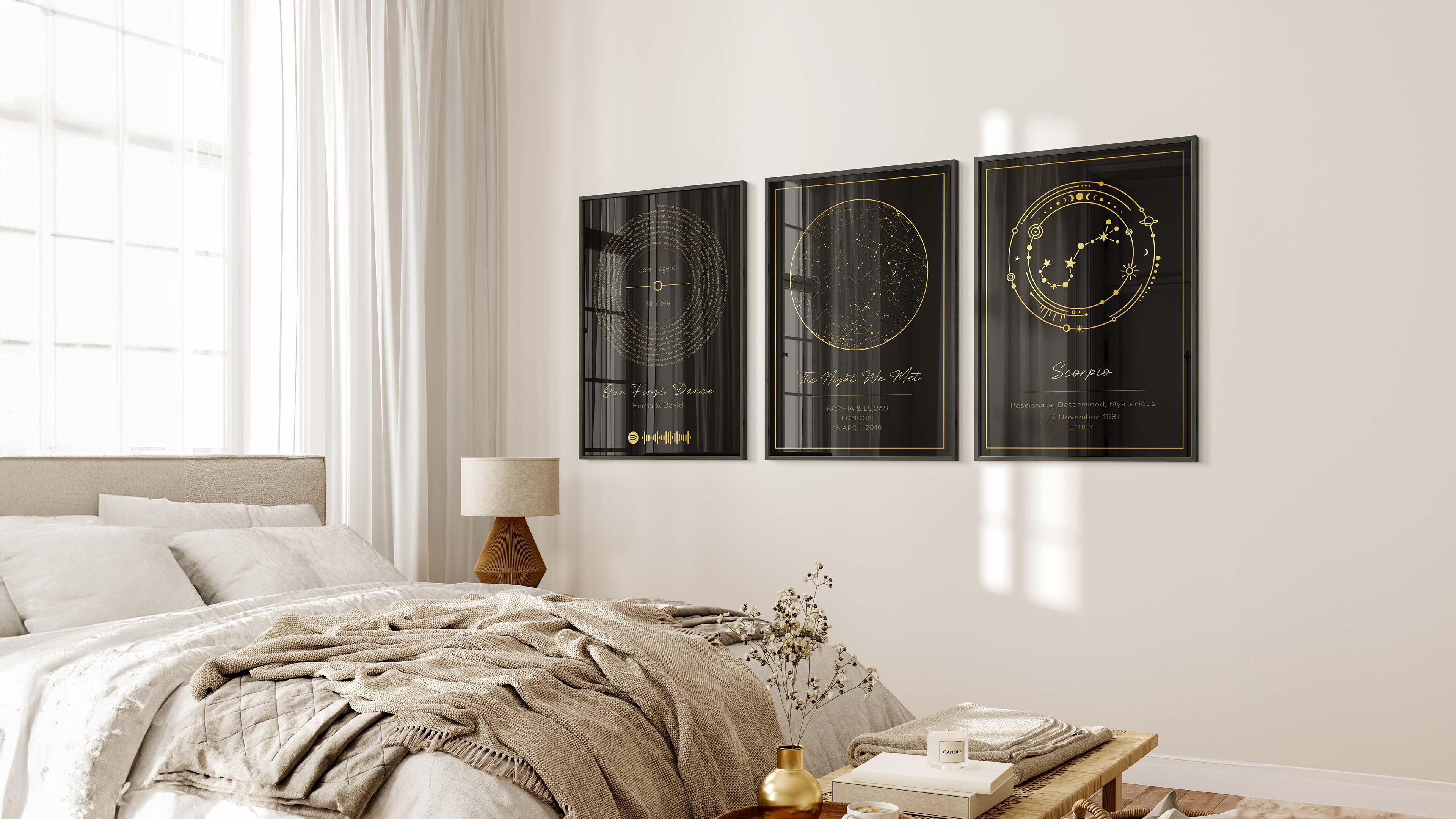 Three custom black wall prints with golden designs: soundwaves of a song, a starry sky map, and a zodiac sign, above a bed